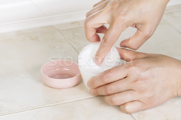 Front part of Female Index finger dipping into cosmetic cream  Stock photo © tab62