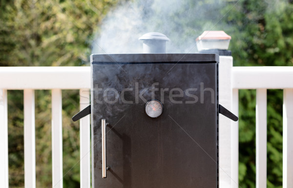 Close up of a smoker with fresh smoke coming out of barbeque coo Stock photo © tab62