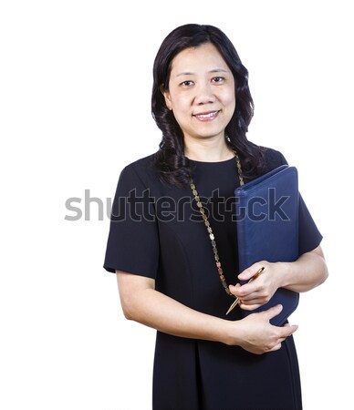 Mature Asian Woman in Business attire with note pad and pen on W Stock photo © tab62