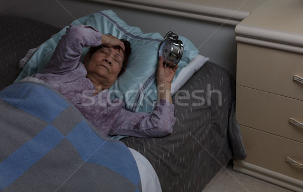 Restless senior woman with migraine during nighttime while in be Stock photo © tab62