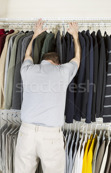 Mature man not happy while getting dressed  Stock photo © tab62