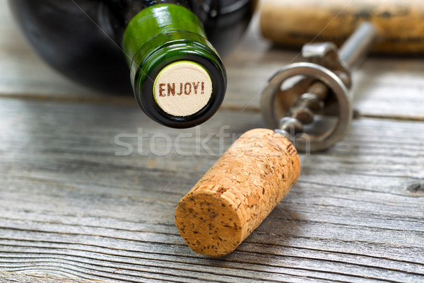 Stock photo: Unopened Red Wine Bottle with opener in background 
