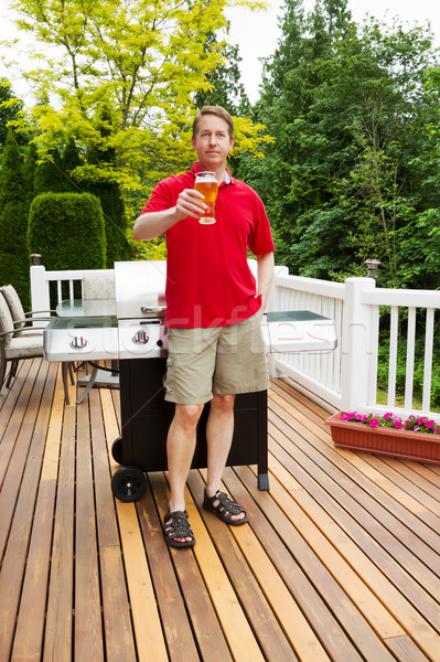 Man enjoying cold beer while preparing to cook outdoors  Stock photo © tab62
