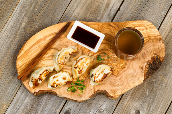 Handmade Chinese dumplings on fancy wooden server with utensils  Stock photo © tab62