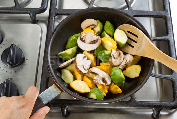 Stirring vegetables in Frying Pan with wooden spoon Stock photo © tab62