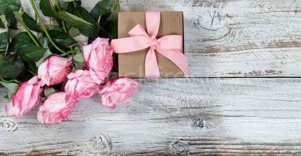 Six pink roses and gift on rustic white wooden background  Stock photo © tab62