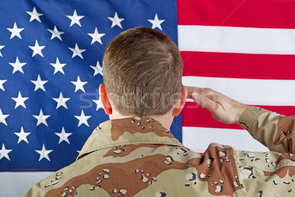 Male soldier saluting large USA Flag while indoors  Stock photo © tab62