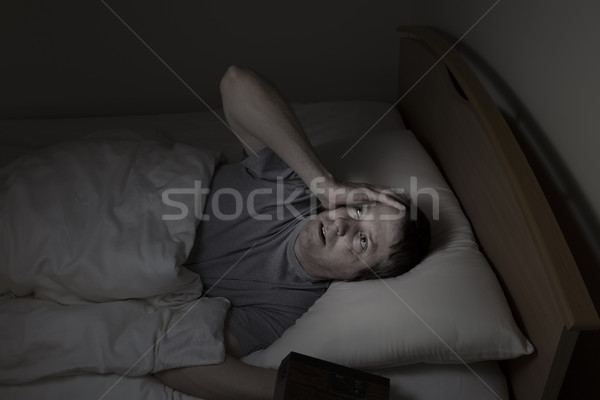 Mature man staring at ceiling during night time while in bed   Stock photo © tab62