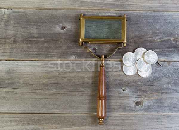 Silver Coins and Magnifying Glass on Wood  Stock photo © tab62