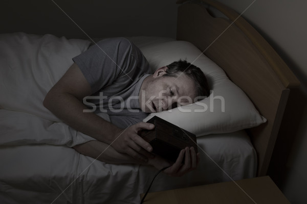 Mature Man checking time while trying to sleep  Stock photo © tab62