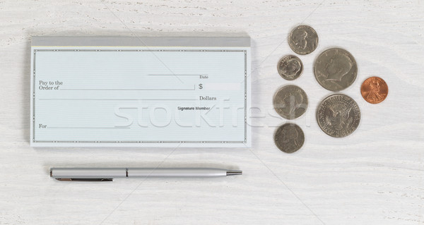 Blank checkbook with pen and coins on white desktop Stock photo © tab62