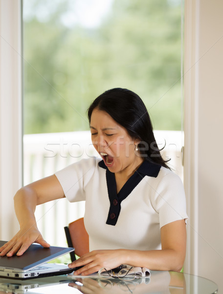 Mature woman slamming her laptop closed while working from home  Stock photo © tab62