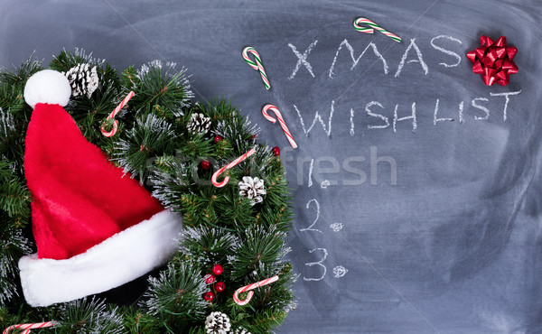 Erased black chalkboard with Santa cap and wreath plus text writ Stock photo © tab62