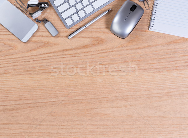 Wooden desktop with office equipment and supplies on upper borde Stock photo © tab62