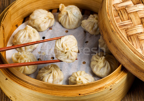 Stock photo: Freshly steamed Chinese dumplings out of bamboo steamer ready to