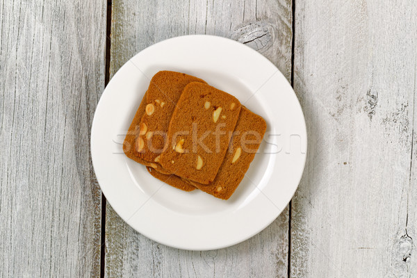 Wafer shaped cookies in plate on aged white wood  Stock photo © tab62