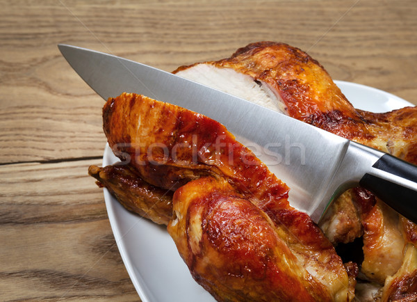 Roasted Chicken being Sliced by Large Sharp Kitchen Knife  Stock photo © tab62