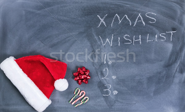 Erased black chalkboard with Santa cap and candy canes plus text Stock photo © tab62