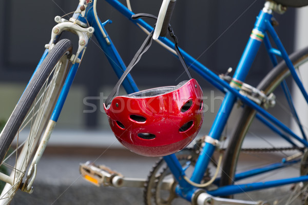 Bright red bicycle helmet hanging from handle bars   Stock photo © tab62