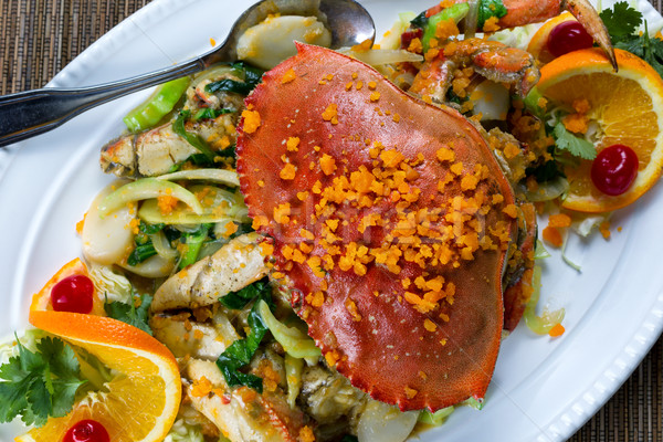 Whole cooked Dungeness crab with cheese and veggies on white ser Stock photo © tab62