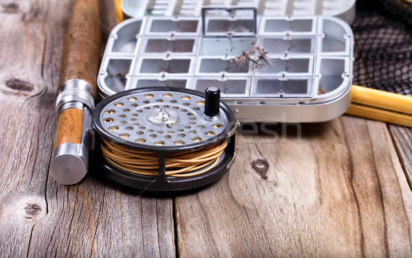 Vintage fly fishing reel and gear on rustic wooden background  Stock photo © tab62