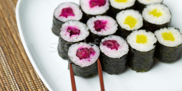 Selecting Pickled Sushi from Plate with Chop Sticks Stock photo © tab62