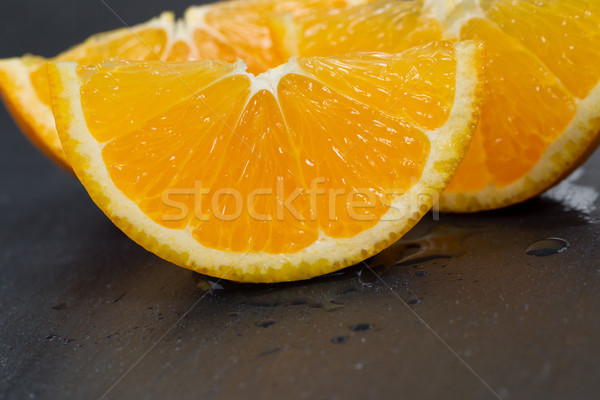 Freshly sliced orange fruit on black slate stone background  Stock photo © tab62
