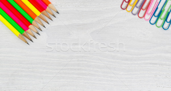 Bright colorful pencils and paper clips on white wooden desktop Stock photo © tab62
