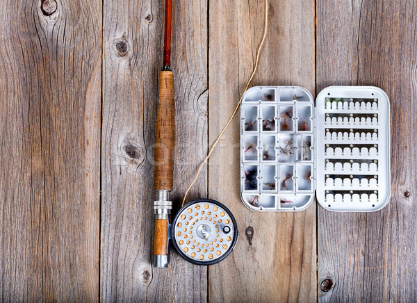 Vintage fishing fly equipment and lure container on rustic woode Stock photo © tab62