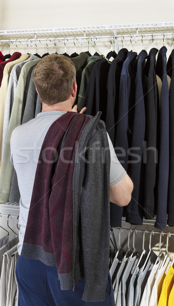 Mature man making decision of which sweater to wear  Stock photo © tab62