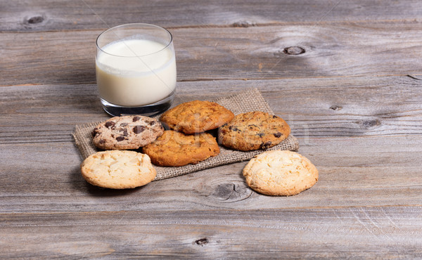 Variety of baked cookies on napkin and glass of milk Stock photo © tab62