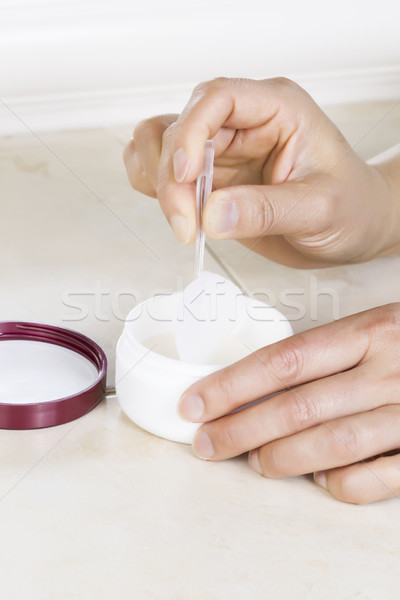 Taking cosmetic application pad out of jar with tweezers  Stock photo © tab62