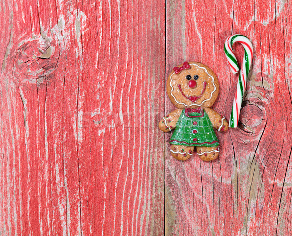 Gingerbread cookie and candy cane on rustic red wooden boards  Stock photo © tab62