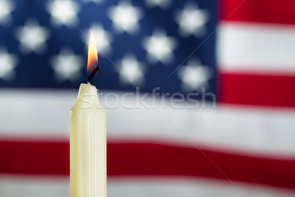Lit candle with blurred out USA flag in background  Stock photo © tab62