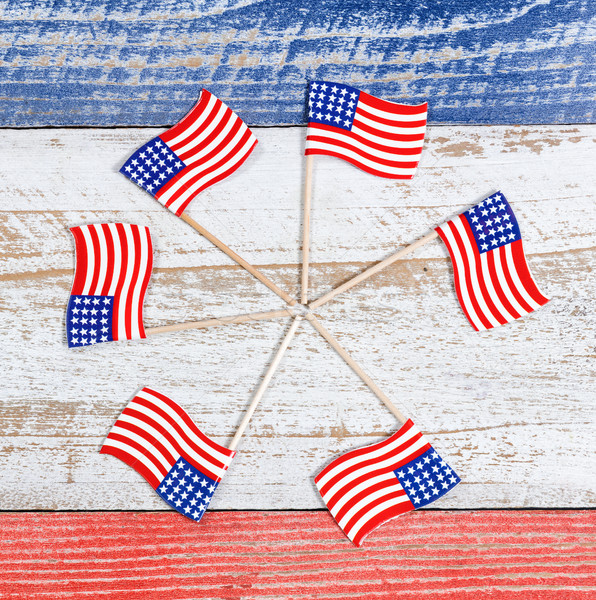 Small USA flags in pinwheel formation on rustic boards with nati Stock photo © tab62