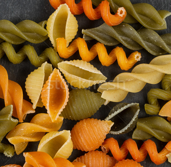 Colorful raw pasta on natural black slate background  Stock photo © tab62