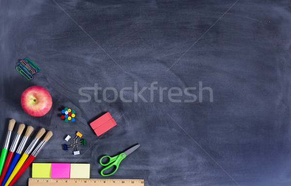 Simple back to school supplies on erased black chalkboard   Stock photo © tab62