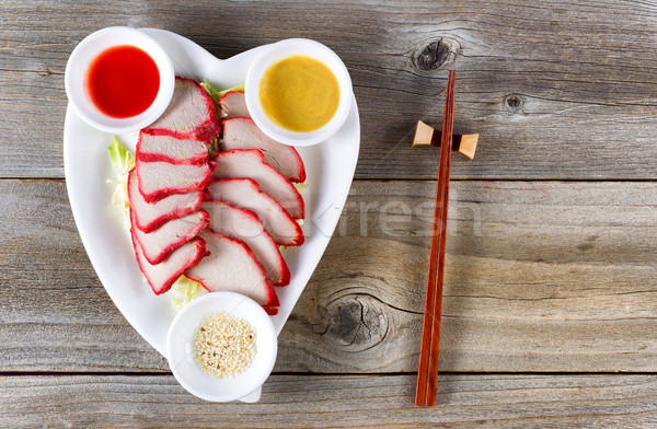 Chinese slice pork dish in heart shaped plate setting ready to e Stock photo © tab62