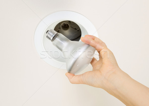 Old Light Bulb being taken out of Recessed Ceiling Mount  Stock photo © tab62