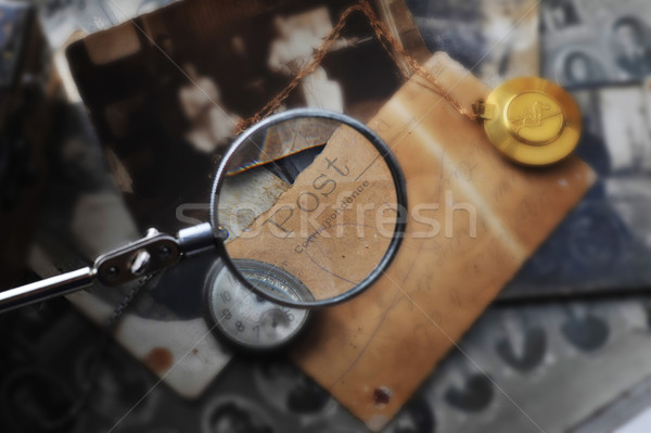 Stock photo: hand with reading-glass on the Post card