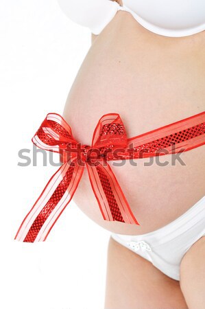 Foto stock: Vermelho · arco · em · torno · de · barriga · jovem · mulher · grávida