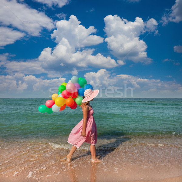 Young woman walking on the beach with colored balloons / Travel Stock photo © Taiga