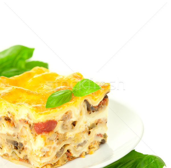 Portion of Classic Lasagna Bolognese with basil herb / isolated  Stock photo © Taiga