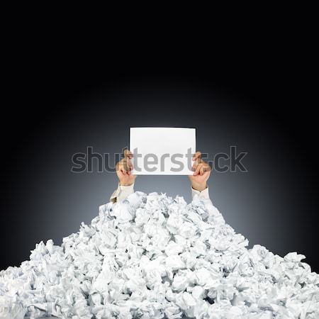 Stock photo: Person under crumpled pile of papers with hand holding a help si