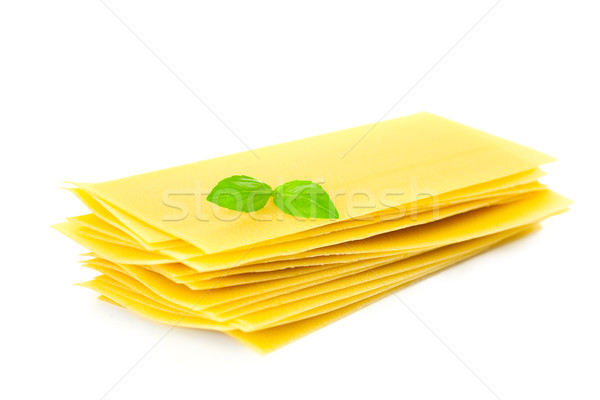 Lasagna pasta with basil herb leaf sprig isolated over white bac Stock photo © Taiga