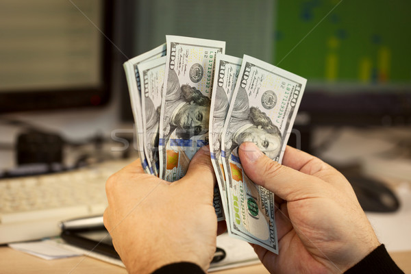 Man hand hold money on office background Stock photo © Taiga