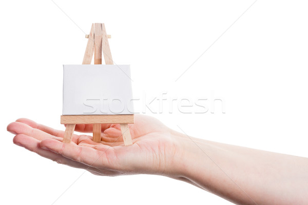 Hand holding easel with canvas Stock photo © Taigi