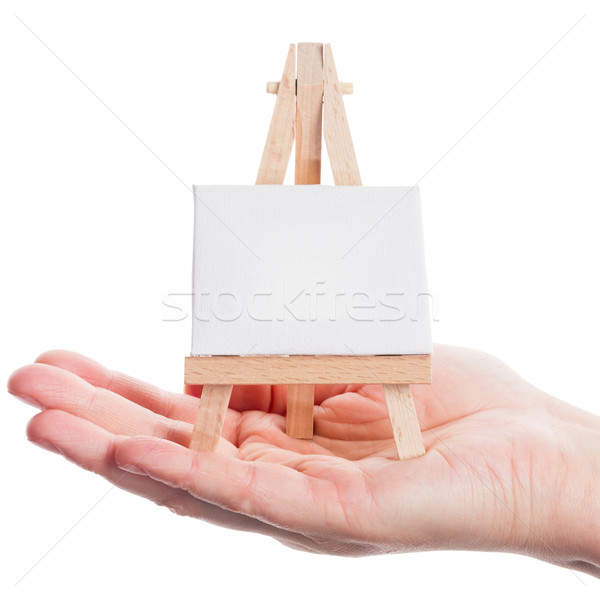 Hand halten Staffelei Leinwand isoliert weiß Stock foto © Taigi