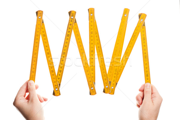 Hands holding wooden folding  ruler Stock photo © Taigi