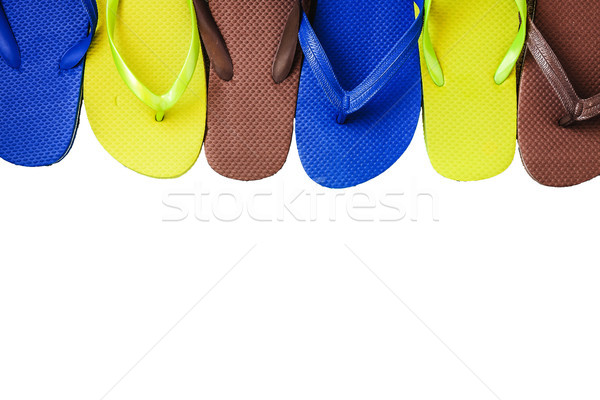 Several pairs of multi-colored rubber flip-flops exhibited in a  Stock photo © TanaCh
